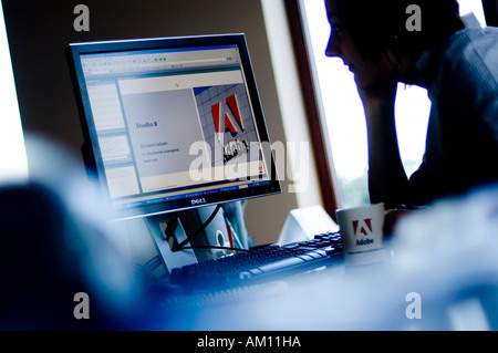 a person learning about Adobe software programmes via a Net based online presentation Stock Photo