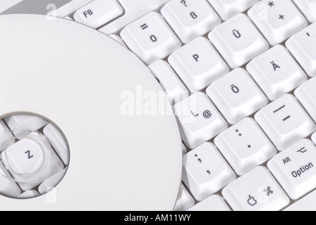 CD/DVD lying on a computer keyboard Stock Photo