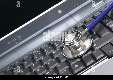 Computer health image of a stethoscope on a laptop keyboard Stock Photo