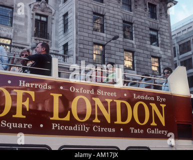 Tourists on top of London tour doubledecker bus with sign showing famous locations, Piccadilly, Mayfair, London Stock Photo