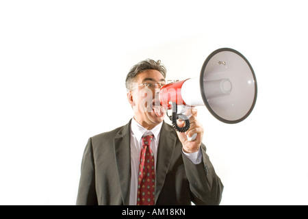Business man screaming into a megaphone Stock Photo