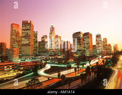 Downtown Los Angeles with rush hour traffic passing on roads and freeways at dusk Stock Photo