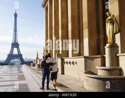 Couple at Palais Chaillot with Golden Figurines and Eiffel Tower Stock Photo