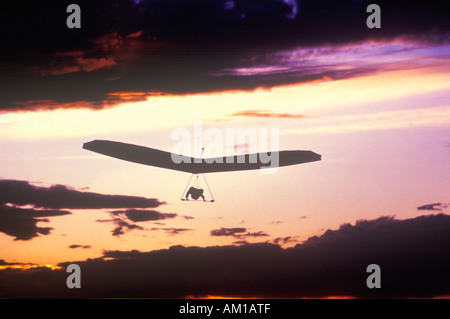 Solar Sailing Hang Gliding in sunset silhouette Stock Photo