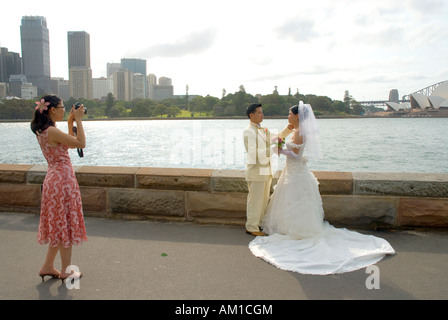 Taking pictures of a married couple before the harbour and Opera House scenery, Port Jackson, Sydney, New South Wales, Australia Stock Photo