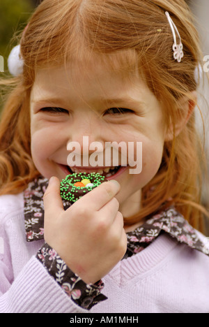 Girl eats sweets at easter time Stock Photo