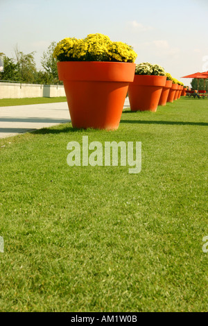 huge orange lifesize flower pots in a row at Federal Garden Exhibition Show 2005  Munich Muenchen Bavaria Germany Stock Photo