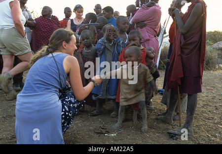 Tourist meeting the Maasai children, Tanzania Stock Photo