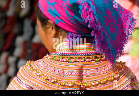 Beadwork on clothing of young Flower Hmong woman in market at Bac Ha in northern Vietnam Stock Photo