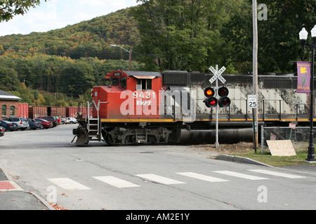 New England Central Railroad Freight Locomotive on a road crossing Stock Photo