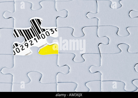 Jigsaw puzzle, the last missing piece revealing a barcode with numbers Stock Photo