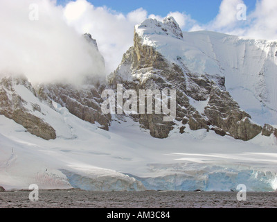 Clouds above the snow covered mountains near the entrance to Paradise Harbor aka Paradise Bay Antarctica Stock Photo