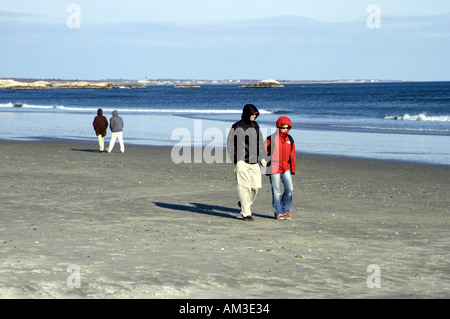Two couples walking on beach in winter Stock Photo