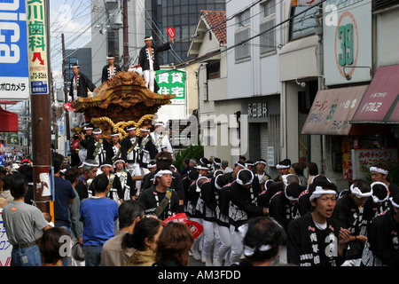Young Japanese men riding a dangerous festival float at the Otori Danjiri Festival in Osaka Japan Asia Stock Photo