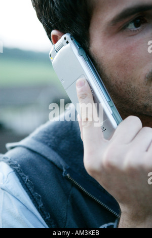 Close up of man using a cordless phone Stock Photo
