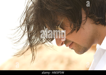 Side view close up of a happy young man looking down Stock Photo