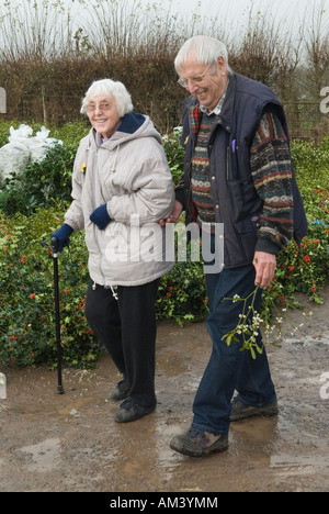 Senior couple with mistletoe berries UK  Mistletoe and Holly Christmas Auction Tenbury Wells Worcestershire 2000s HOMER SYKES Stock Photo