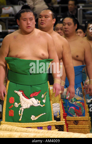 Sumo wrestlers in colourful traditional ceremonial silk robes enter the stadium in Osaka Kansai Japan ancient Asian sport Stock Photo