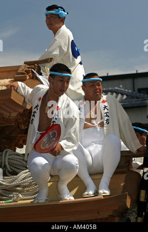 Japanese men in traditional costume riding on a danjiri festival float at the Kishiwada Danjiri in Osaka Kansai Japan Asia Stock Photo