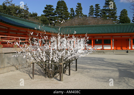 Bad luck messages omikuji tied to a tree in Heian jingu shrine to blow away the bad luck Stock Photo