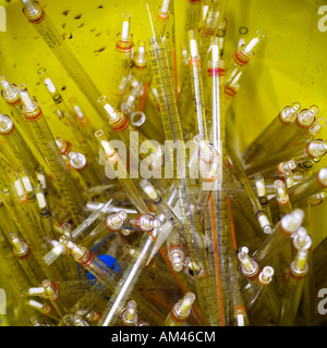 Laboratory work clinical trials research testing used pipettes discarded in waste Stock Photo