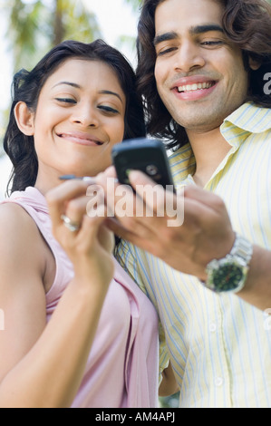 Close-up of a young couple using a mobile phone Stock Photo