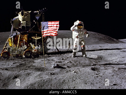 Apollo 16  Commander John Young jumps while saluting the flag. Stock Photo