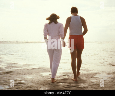 couple walks on the beach Stock Photo