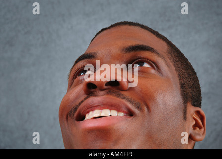 African American man looking up and smiling Stock Photo