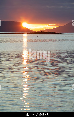 The setting sun between the Isles of Rum and Eigg from near Arisaig ...