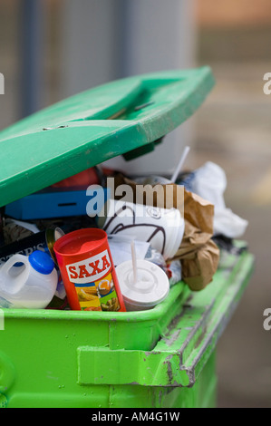 A green coloured commercial waste bin overflows with rubbish in Brighton city centre.Picture by Jim Holden. Stock Photo