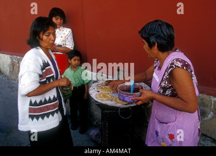 Mexican woman food vendor selling memelita memelitas Mexican food in Oaxaca de Juarez in Oaxaca State in Mexico Stock Photo