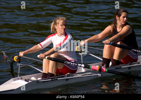 Two female rowers train on the River Thames, East Molesey, Surrey, UK. Stock Photo