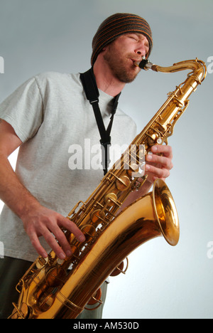young musician playing a saxaphone Stock Photo