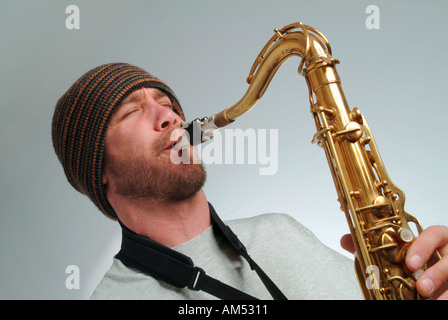 young musician playing a saxophone Stock Photo