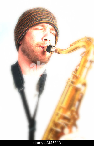 young musician playing a saxophone Stock Photo