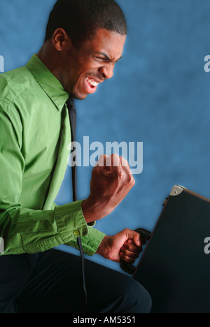 An African American business man celebrates Stock Photo