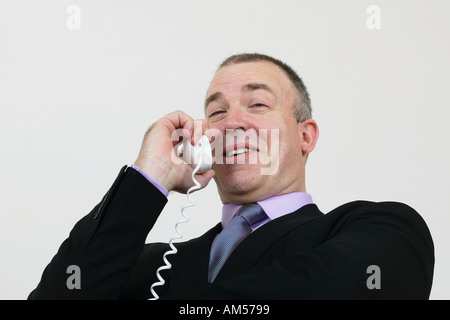 Businessman having animated conversation on telephone Stock Photo