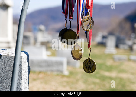 Victory medals hanging from a tombstone at the cemetery of Harpers Ferry West Virginia USA Stock Photo