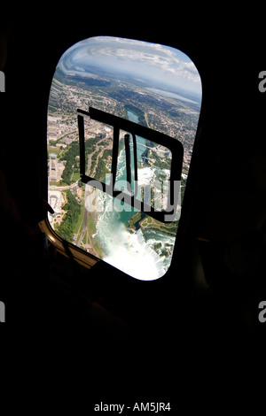 Aerial view of Horseshoe Falls, Niagara Falls and Rainbow Bridge. Shot through open helicopter window. Canadian and American. Stock Photo