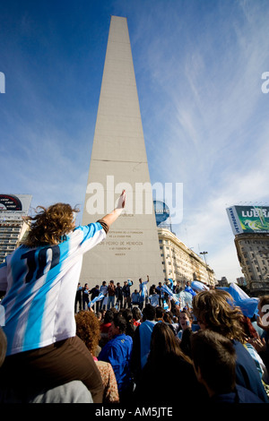 Soccer fans sing and wave Argentinian flags underneath the Obelisk in Buenos Aires. Stock Photo