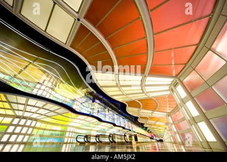 Extreme wide angle image of empty moving sidewalk in the tunnel at Chicago O'Hare airport with moving neon light patterns Stock Photo