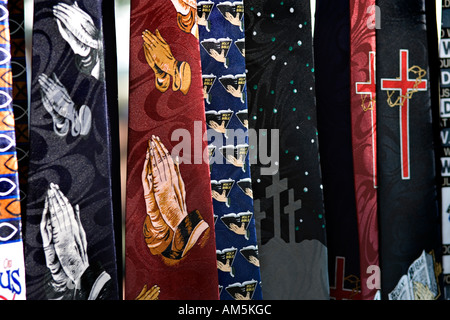 USA: Colorful neckties showing Christian evangelical religious symbols: Holy Bibles; hands in prayer; Golgotha; Holy Cross. Stock Photo