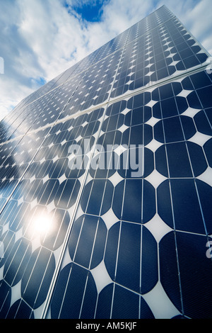 Solar panels producing electricity. Rows of monocrystalline photovoltaic solar cell panels on a roof. Stock Photo