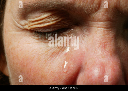 Eye with a teardrop Stock Photo