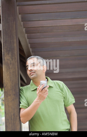 Low angle view of a mid adult man using a mobile phone Stock Photo