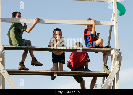 Children with ice cream sitting on a tribune, Loma Plata, Chaco, Paraguay Stock Photo