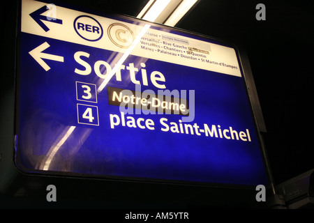 Overhead direction sign in the Paris Metro pointing to Notre Dame and place Saint Michel Stock Photo