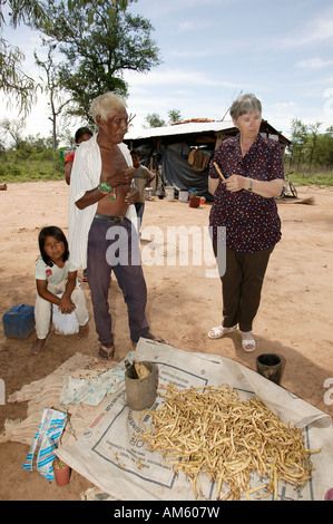 Female doctor with Nivaclé native Americans, beans for using lying on a Jothoisha, Chaco, Paraguay, South America Stock Photo