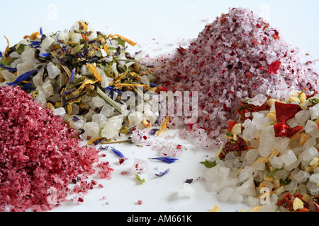 Colourful sea salts, with several spices and herbs like hibiscus, rose petals, chili and paprika Stock Photo